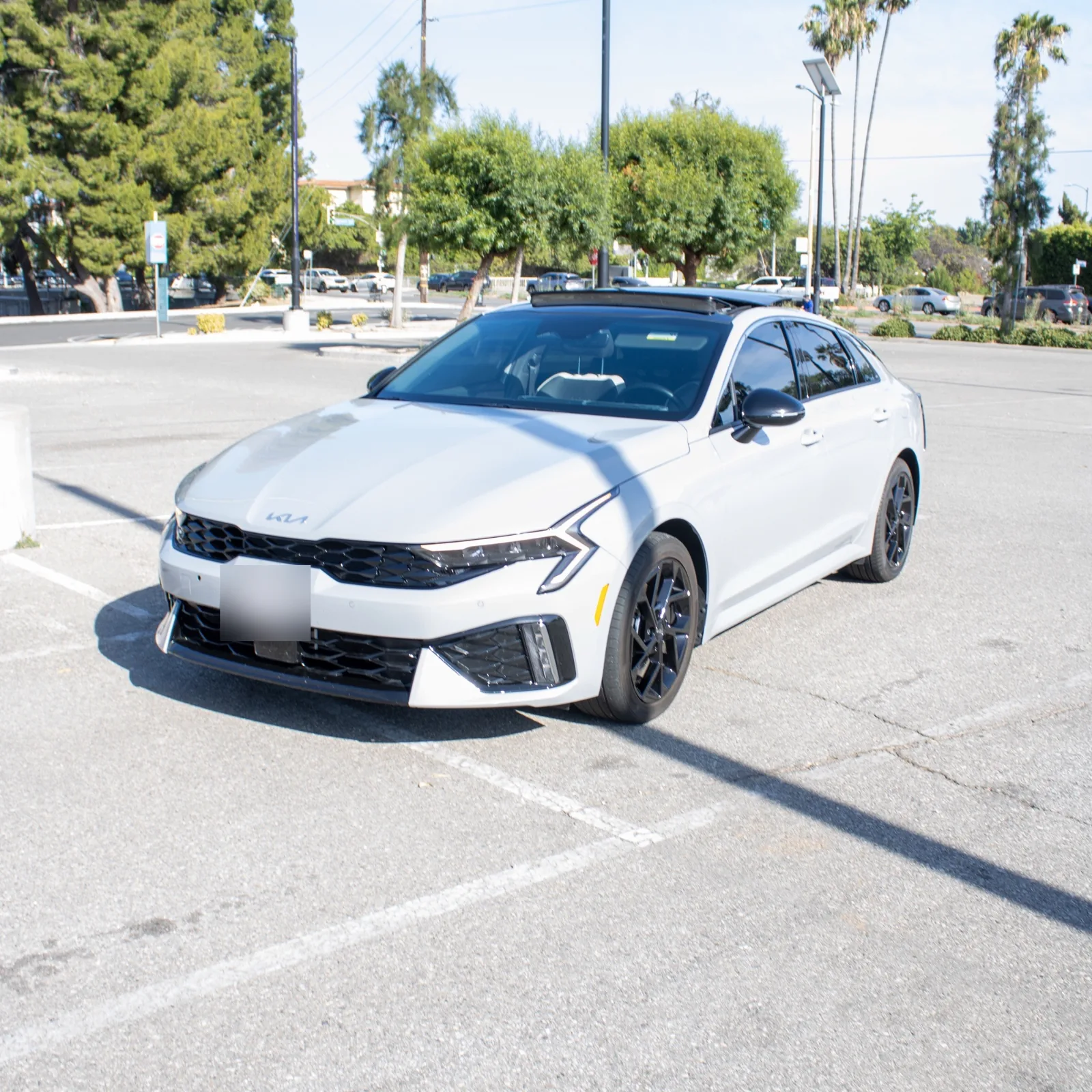 Grey Kia K5, front three-quarter
